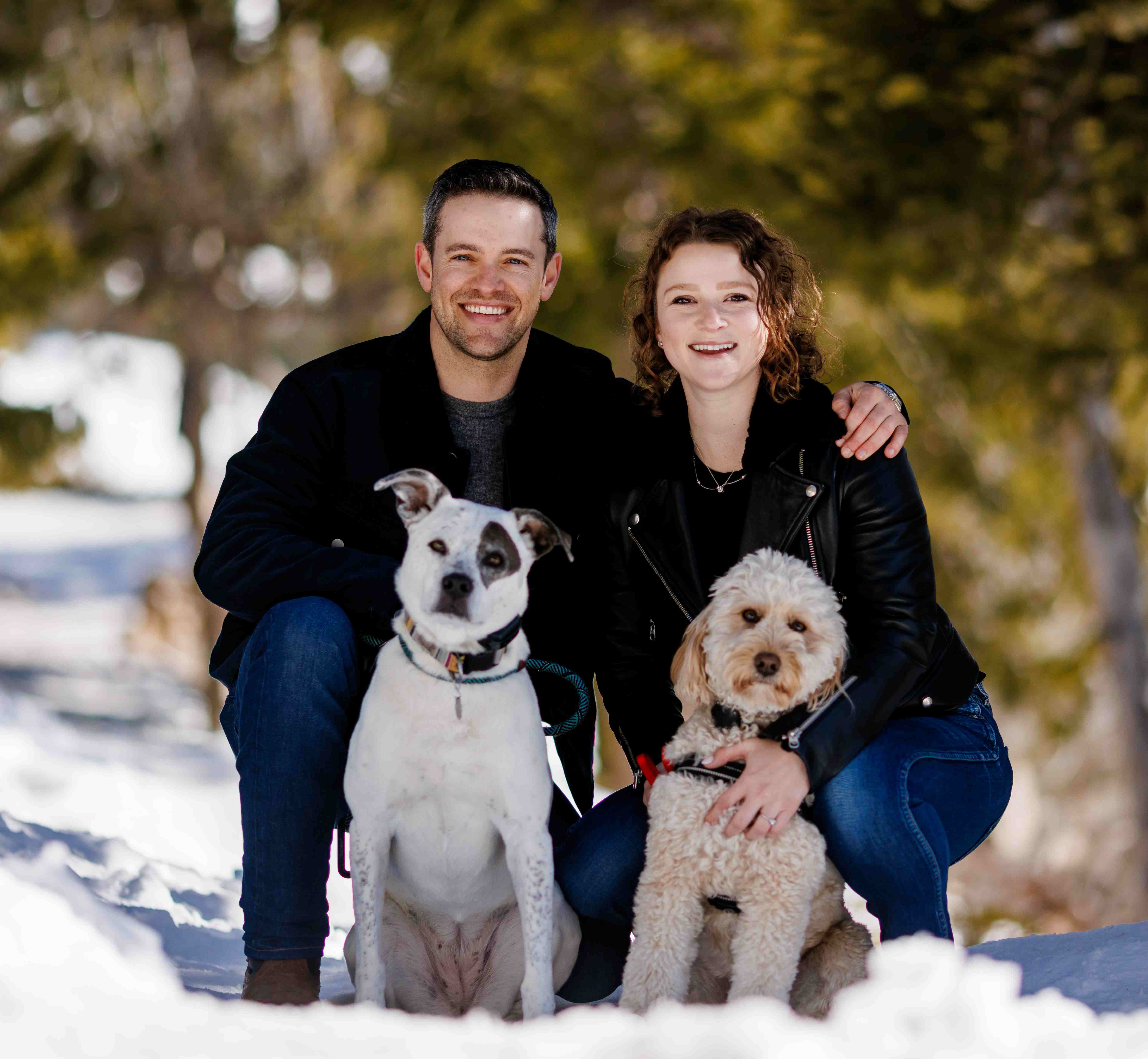 Goldy with her husband and dogs in a snowy setting